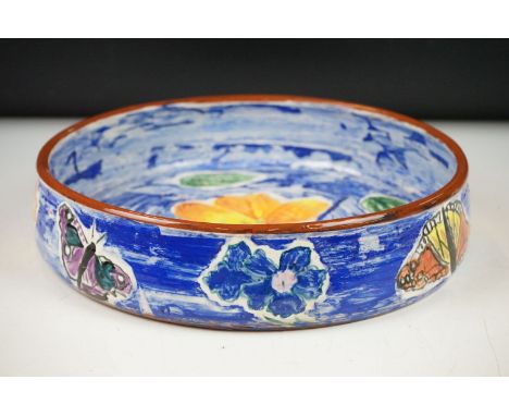 Hazel Leach studio pottery circular bowl, with hand painted floral and butterfly decoration on a blue ground, signed to rever