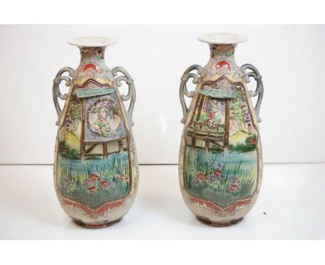 Pair of large Famille Verte twin-handled baluster vases, flared necks, the vases relief moulded with ladies on platforms rais