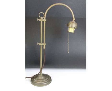 Edwardian brass adjustable desk lamp, with reeded support, raised on a circular base. Measures 55.5cm tall 