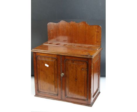 Early 20th century mahogany smokers cabinet, the doors opening to three drawers, pipe rack to top. Measures 37.5cm high 