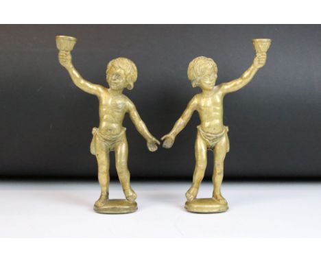 Pair of brass cherub lamp fittings. Measure approx 22cm high 