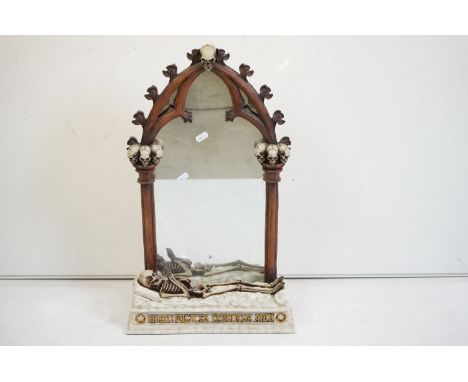 A contemporary gothic style mirror with skeleton decoration. 