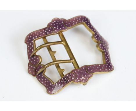 An antique brass shoe buckle with ornate purple enamel decoration. 