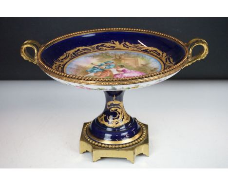 19th Century French porcelain tazza with hand painted central panel depicting a courting couple (signed G. Maurice) on a coba