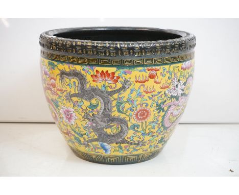 Chinese yellow ground jardiniere, with enamel decoration depicting dragons amongst scrolling foliage, black &amp; gilt incise