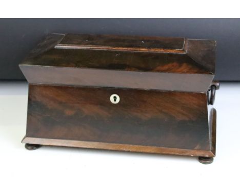 William IV mahogany sarcophagus tea caddy, with twin loop handles, the lid opening to a pair of removable caddies and matched
