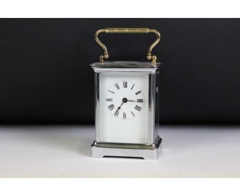 An late 19th / early 20th century carriage clock, brassed cased with nickel plating, beveled glass panels and white enamel di