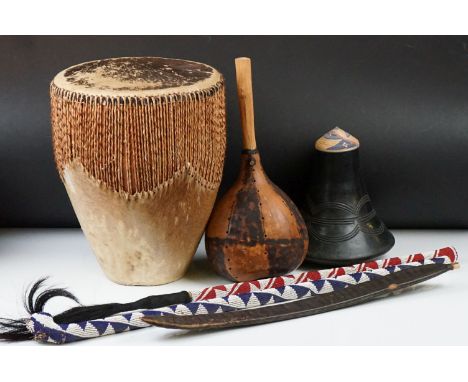 A group of African tribal collectables to include a drum, marriage stick, fly whisk and musical instruments. 