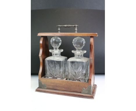 Early 20th century Two Bottle Oak Tantalus with a pair of cut glass decanters. 