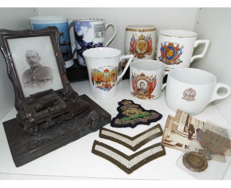 A mixed lot of military and Royal memorabilia to include an early 20 th century (WW1) NAAFI crested mug, a hallmarked silver 