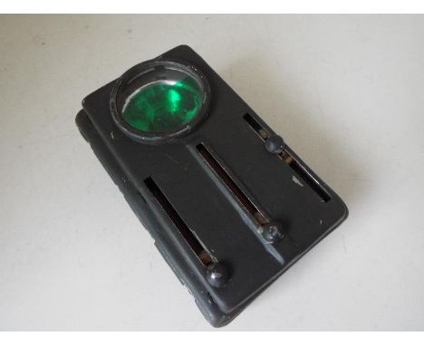An Army Signal flashlight with red, amber and green filters