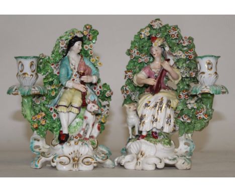 Pair of 18th century Derby candlestick figures modelled as a gentleman and a lady musician on scroll bases, 20cm high 