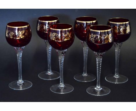 Collection of six ruby coloured wine glasses with an overlaid gilt design of fruiting vines, the glasses 19cm high (6) 