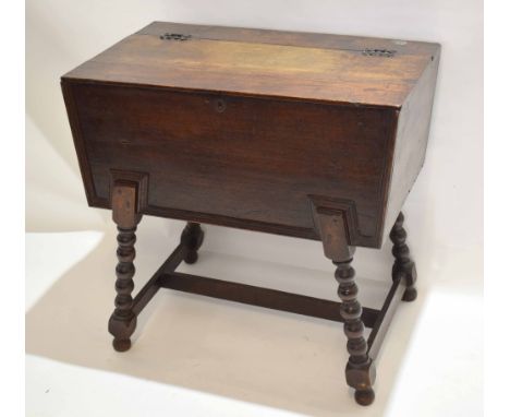 Late 17th/early 18th century oak bible box cupboard on associated stand with decorative cast hinges with lift up top on a bob