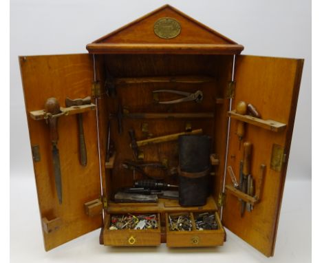 Early 20th century 'Army &amp; Navy' oak wall mounted rectangular tool cabinet with arched pediment with early 20th century a