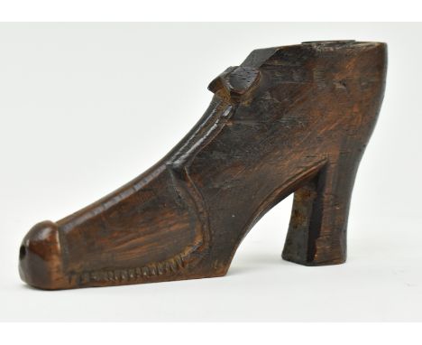 A 19th century carved treen wooden snuff box in the form of a shoe. The shoe in a 17th century style featuring bow &amp; heel