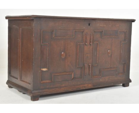 An early 18th century carved oak block fronted coffer / blanket box chest. The coffer having a flared rectangular hinged top 