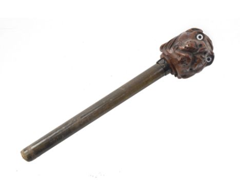 A Victorian 19th century wooden walking stick pommel carved as the head of a dog. The pommel having a circular metal plaque e