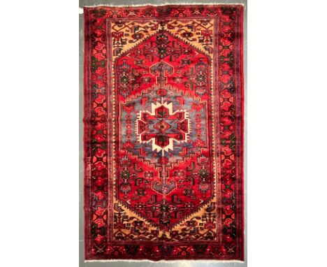 An early 20th century North West Persian Islamic Zanjan floor carpet rug. The rug a series of central medallions of geometric