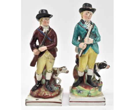 A pair of early 19th century Staffordshire pearlware figurines of huntsman. Each figure complete with shotgun and hunting dog