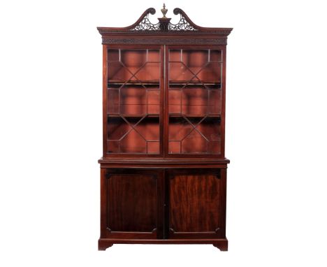 A George III mahogany bookcase , circa 1780  A George III mahogany bookcase  , circa 1780, the pierced swan neck pediment set