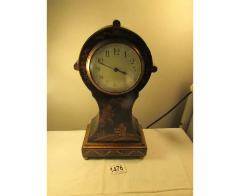 A lacquered mantel clock with Japanese scene.