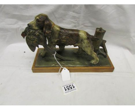 A painted spaniel with a pheasant in its mouth as a table lighter.