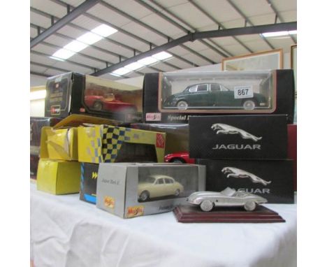 A collection of boxed large scale die cast model cars and a pewter E type Jaguar.