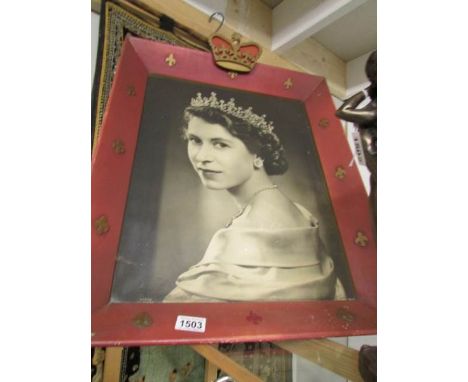 A framed portrait photograph of Queen Elizabeth II.