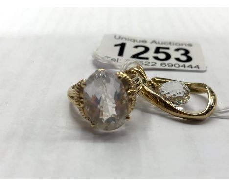 A rock crystal gold ring and pendant.