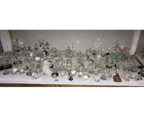 A shelf of small glass ornaments mostly dogs, mice &amp; birds