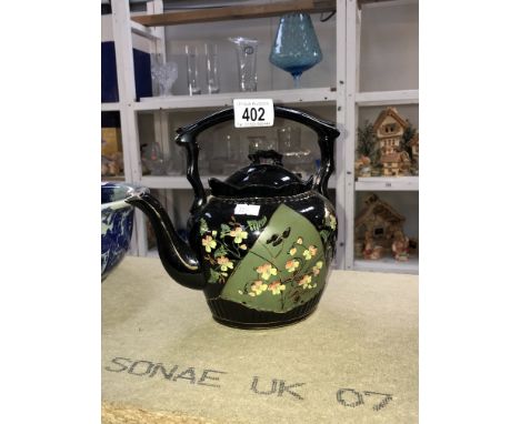 A black &amp; floral teapot with gilded trim &amp; details