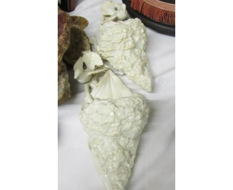 A pair of ceramic wall sconces surmounted birds.