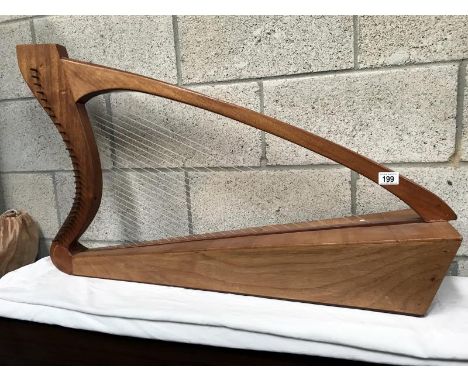 A handmade harp inscribed (?) K. Cain MCMLXXV, West Dean Fecit. Approximate height 44"