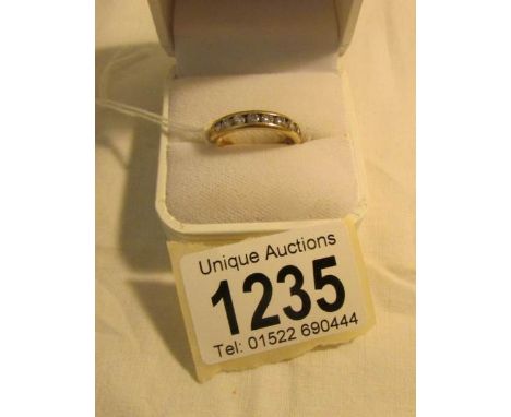 A 14k gold and diamond eternity ring, size O. (with certificate).