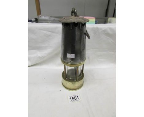 A brass and metal miner's lamp.
