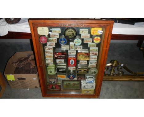 A cased display of vintage tins.