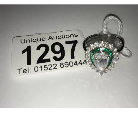 An 18ct white gold fine quality art deco style emerald and diamond ring. Large central rose cut pear shaped diamond of 1.01ct