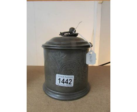A pewter tea caddy.