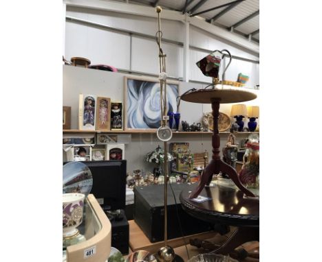 A brass effect floor standing spot light