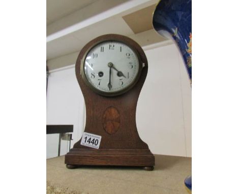 An oak inlaid mantel clock, springs ok.