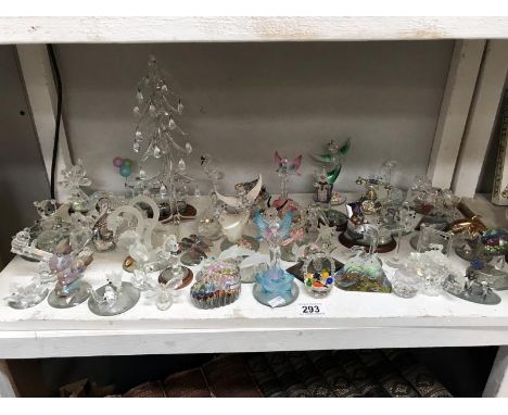 A shelf of small glass ornaments, animals, angels &amp; fairies etc.