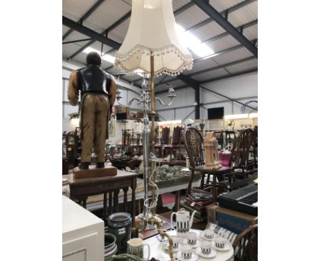 A brass lamp stand with shade