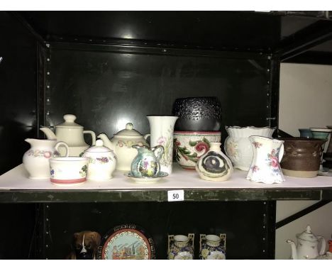 A shelf of pottery items including planters etc.