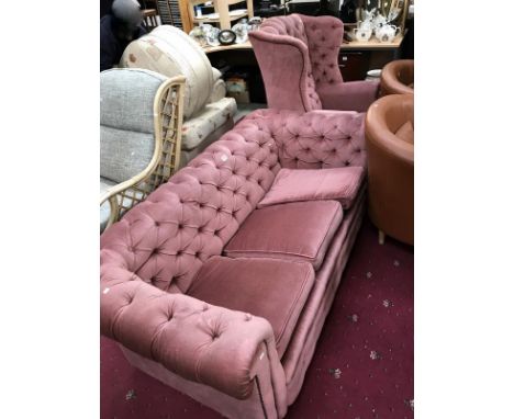 A pink button back Chesterfield sofa and a button back chair