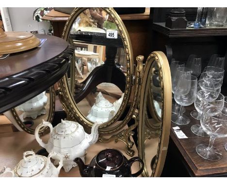 A dressing table triptych mirror in gold frame and  a gold patinated standard lamp