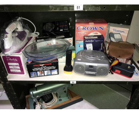 A shelf of electrical items including CD player etc.