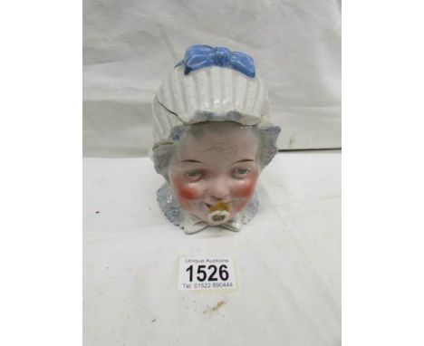 A ceramic tobacco jar as a baby with dummy (a/f, chips).