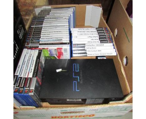 A Playstation 2 computer console with assortment of games.