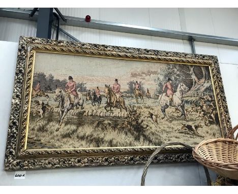 A framed tapestry depicting a hunting scene